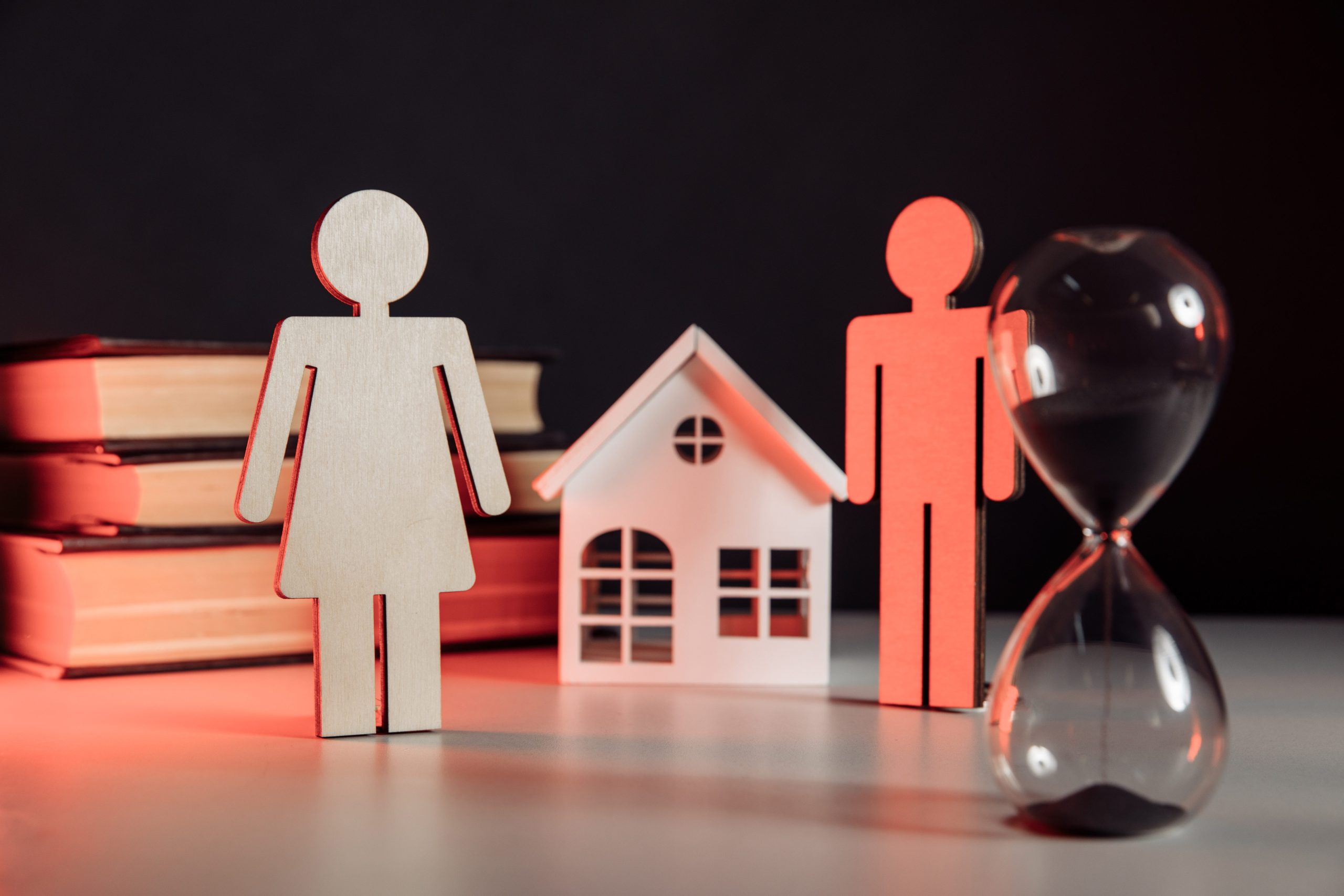 Wooden model of tenant and landlord, house and hourglass. Portraying concept of eviction
